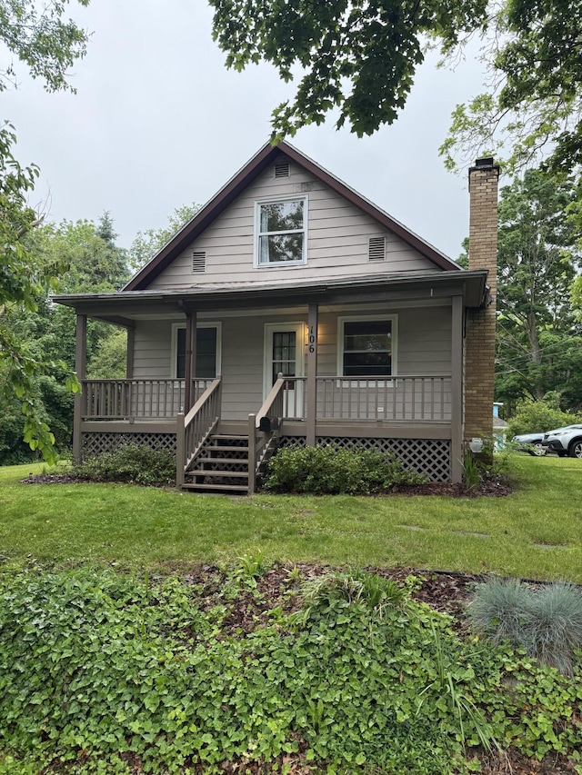 106 S Berkley St, Kalamazoo, MI 49006 - view of front of property featuring a chimney, a porch, and a front lawn