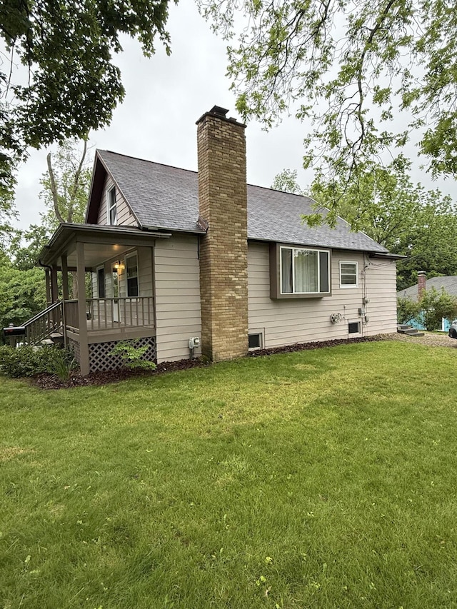 106 S Berkley St, Kalamazoo, MI 49006 - back of property with a yard, a chimney, covered porch, and a shingled roof