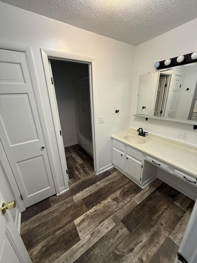 106 S Berkley St, Kalamazoo, MI 49006 - bathroom featuring wood finished floors, vanity, and a textured ceiling