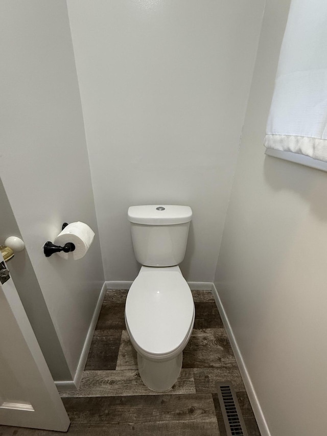 106 S Berkley St, Kalamazoo, MI 49006 - bathroom featuring toilet, wood finished floors, and baseboards