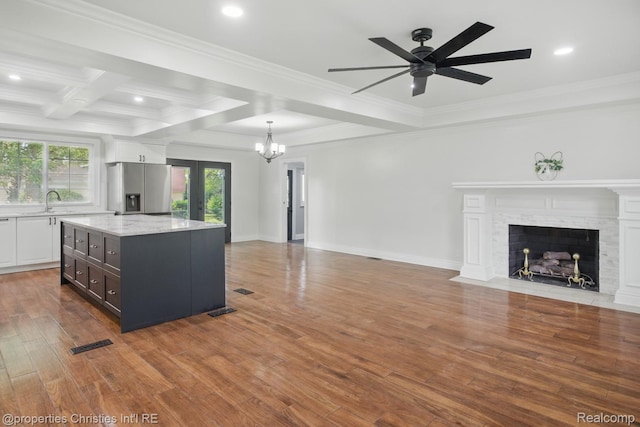 18051 Locherbie Ave, Beverly Hills, MI 48025 - kitchen with stainless steel fridge with ice dispenser, open floor plan, white cabinetry, wood finished floors, and a ceiling fan