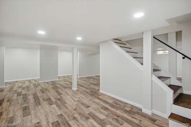 18051 Locherbie Ave, Beverly Hills, MI 48025 - finished basement with light wood-type flooring, stairway, recessed lighting, and baseboards