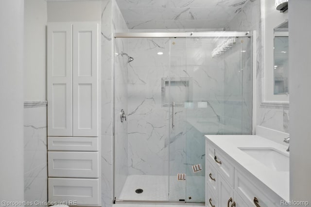 18051 Locherbie Ave, Beverly Hills, MI 48025 - bathroom featuring a marble finish shower, vanity, and tile walls