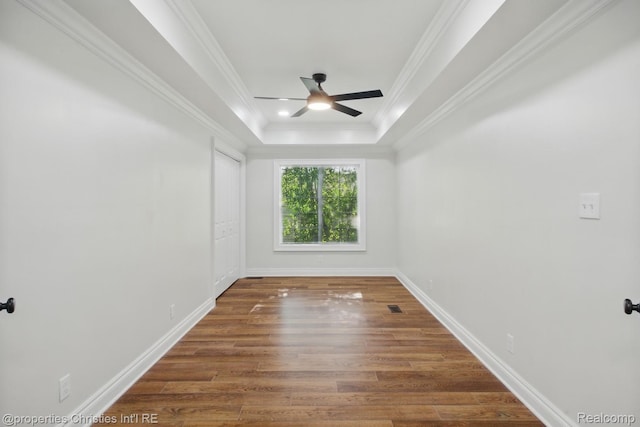 18051 Locherbie Ave, Beverly Hills, MI 48025 - unfurnished room featuring a ceiling fan, wood finished floors, baseboards, a raised ceiling, and crown molding