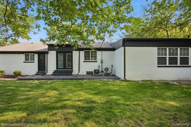 18051 Locherbie Ave, Beverly Hills, MI 48025 - rear view of property featuring brick siding, a lawn, entry steps, and central AC