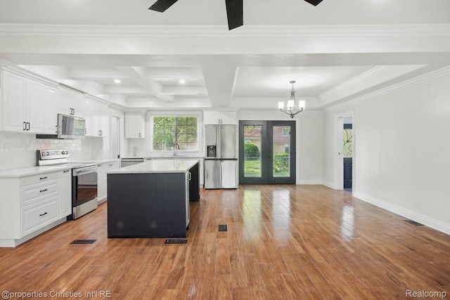 18051 Locherbie Ave, Beverly Hills, MI 48025 - kitchen with stainless steel appliances, a chandelier, white cabinetry, light wood-style flooring, and light countertops