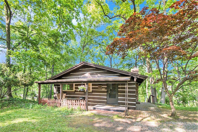 8721 Onandaga Rd, Clarkston, MI 48348 - view of front of house featuring a chimney and a porch
