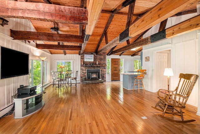 8721 Onandaga Rd, Clarkston, MI 48348 - living room featuring wooden ceiling with exposed beams, hardwood / wood-style flooring, baseboard heating, a brick fireplace, and high vaulted ceiling