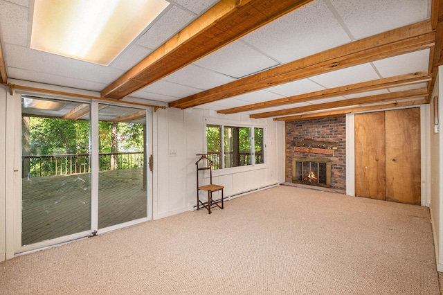8721 Onandaga Rd, Clarkston, MI 48348 - unfurnished living room featuring carpet floors, beam ceiling, a fireplace, and a baseboard heating unit