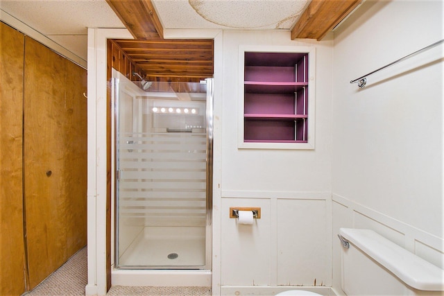 8721 Onandaga Rd, Clarkston, MI 48348 - bathroom featuring toilet, a shower stall, and wainscoting