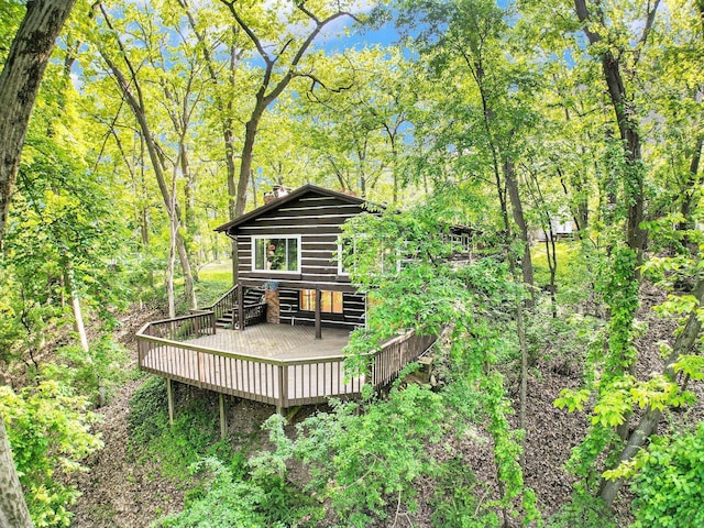 8721 Onandaga Rd, Clarkston, MI 48348 - rear view of property with a deck and faux log siding