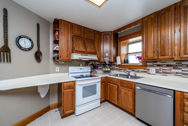 2311 E Glendora Rd, Buchanan, MI 49107 - kitchen with stainless steel dishwasher, white electric range oven, a sink, under cabinet range hood, and light countertops