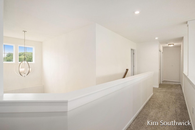 12285 Apple Cart Ln, Lowell, MI 49331 - corridor with a chandelier, an upstairs landing, recessed lighting, light carpet, and baseboards