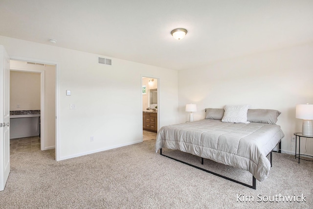 12285 Apple Cart Ln, Lowell, MI 49331 - carpeted bedroom with baseboards and connected bathroom