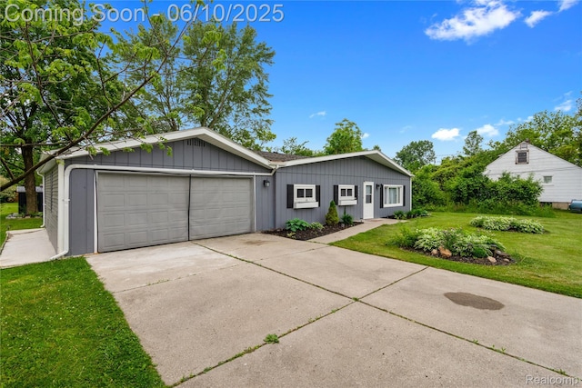 2062 Vermont Dr, Troy, MI 48083 - view of front of property with a front yard, concrete driveway, a garage, and board and batten siding