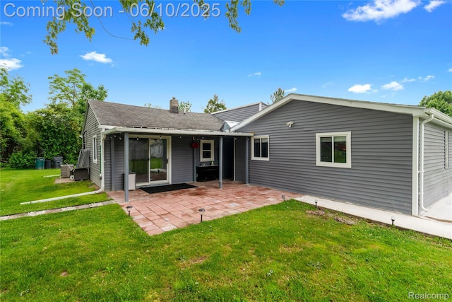 2062 Vermont Dr, Troy, MI 48083 - rear view of property featuring a chimney, a lawn, and a patio area