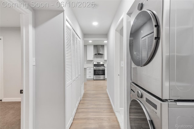 2062 Vermont Dr, Troy, MI 48083 - laundry room with stacked washing machine and dryer, baseboards, recessed lighting, and light wood-style floors