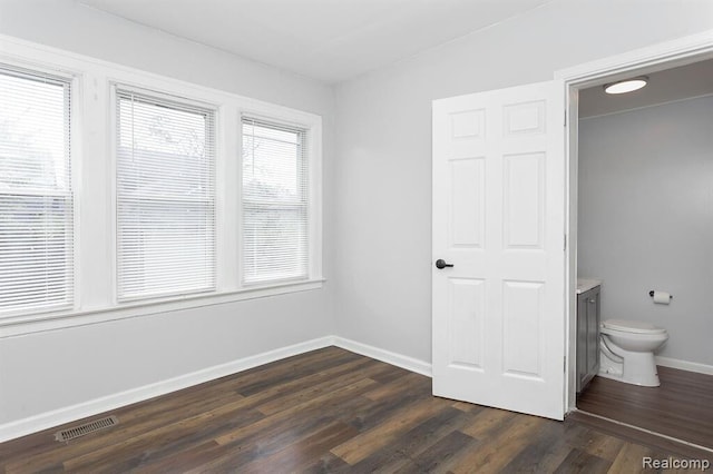 3485 Bedford St, Detroit, MI 48224 - unfurnished bedroom featuring dark wood-style floors and connected bathroom