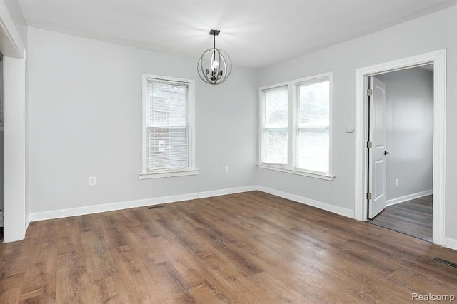3485 Bedford St, Detroit, MI 48224 - spare room featuring plenty of natural light, a chandelier, and dark wood-style floors