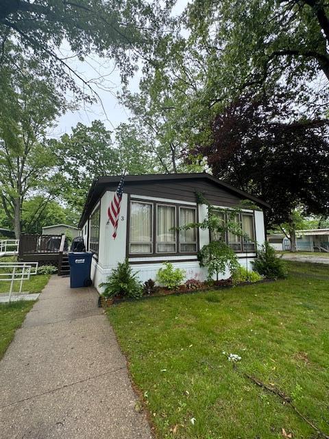 583 S Mcintosh Ln, Muskegon, MI 49442 - manufactured / mobile home featuring a front yard and concrete driveway