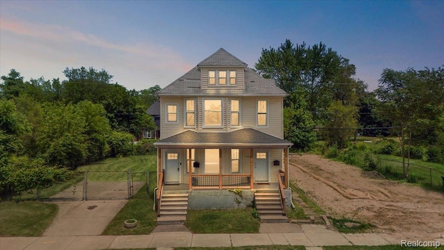 2160 Concord St, Detroit, MI 48207 - traditional style home featuring a porch and a gate
