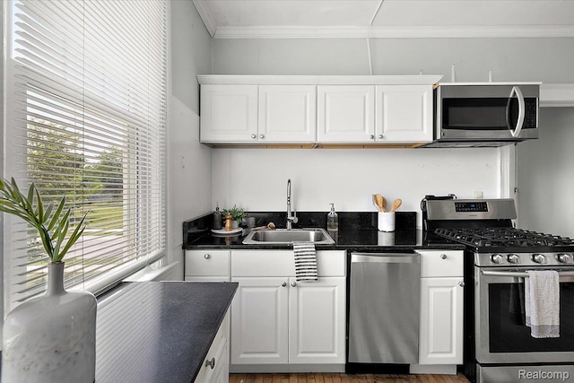 2160 Concord St, Detroit, MI 48207 - kitchen with stainless steel appliances, white cabinets, and crown molding