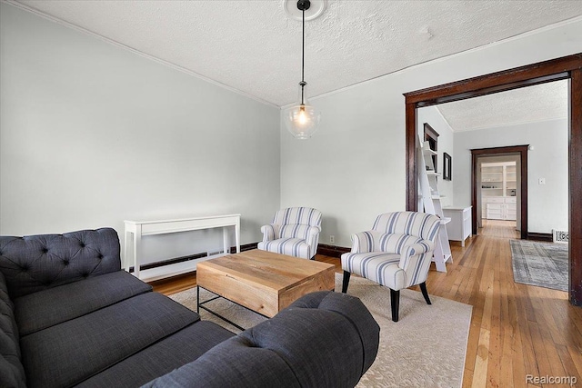 2160 Concord St, Detroit, MI 48207 - living room with a textured ceiling, wood-type flooring, a baseboard radiator, and crown molding