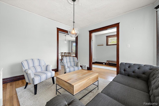 2160 Concord St, Detroit, MI 48207 - living area featuring a textured ceiling, wood finished floors, and ornamental molding