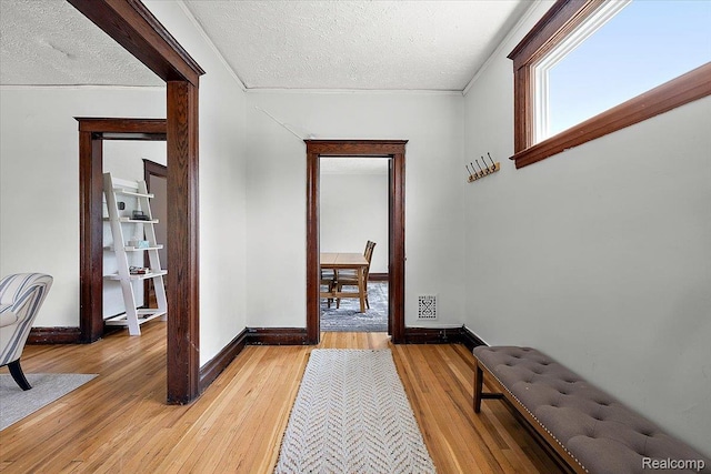 2160 Concord St, Detroit, MI 48207 - hallway featuring a textured ceiling, light wood-style floors, and crown molding