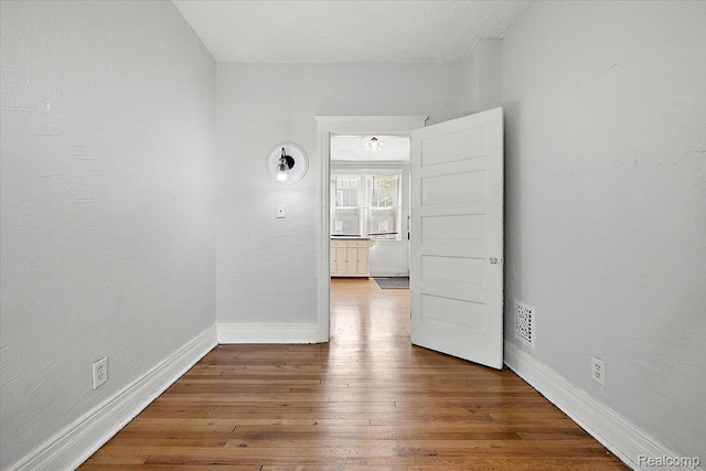 2160 Concord St, Detroit, MI 48207 - unfurnished room with baseboards and wood-type flooring