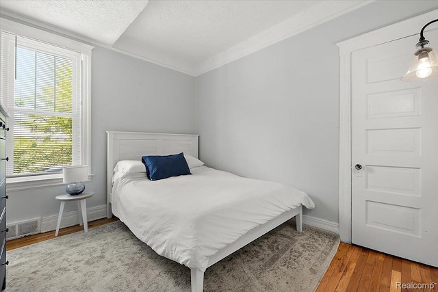 2160 Concord St, Detroit, MI 48207 - bedroom featuring a textured ceiling, wood finished floors, and ornamental molding