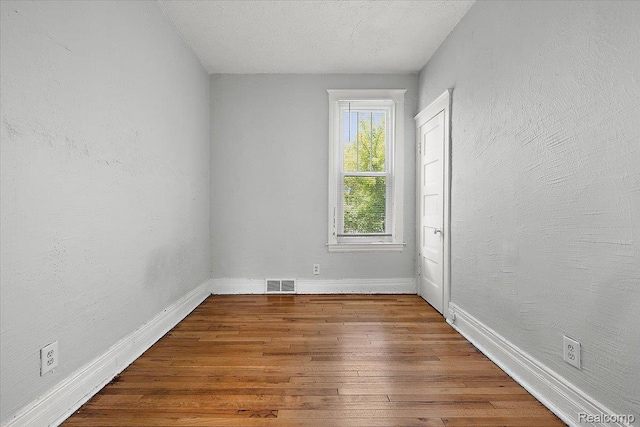 2160 Concord St, Detroit, MI 48207 - unfurnished room with baseboards and hardwood / wood-style floors