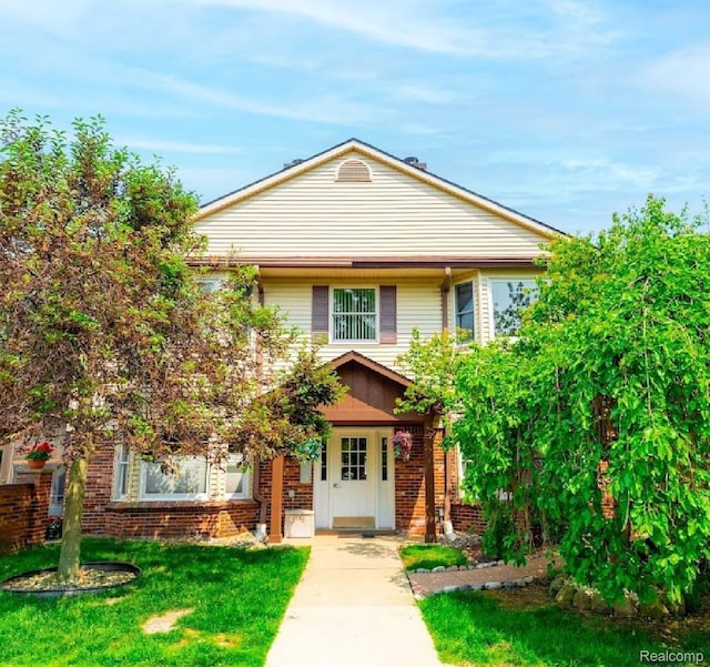 8597 Mathias Dr # 37, Grosse Ile, MI 48138 - view of front of house with brick siding and a front lawn