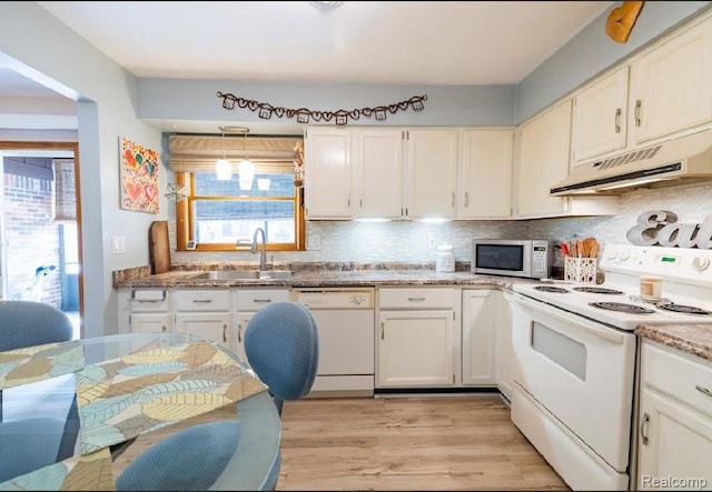 8597 Mathias Dr # 37, Grosse Ile, MI 48138 - kitchen with white appliances, a sink, under cabinet range hood, decorative backsplash, and light wood-type flooring