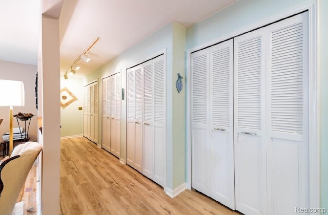 8597 Mathias Dr # 37, Grosse Ile, MI 48138 - corridor with light wood-style floors and track lighting