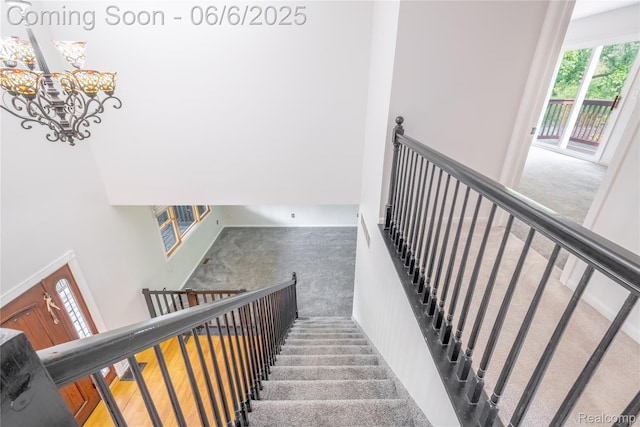 12631 9 Mile Rd, South Lyon, MI 48178 - stairway featuring carpet, a chandelier, and a towering ceiling