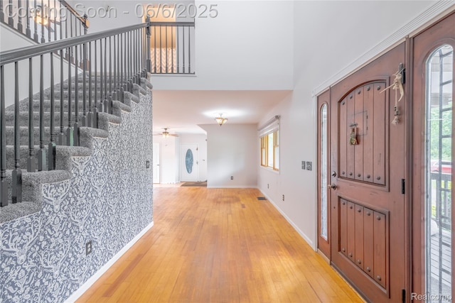 12631 9 Mile Rd, South Lyon, MI 48178 - entrance foyer featuring plenty of natural light, light wood-style floors, stairway, baseboards, and a towering ceiling