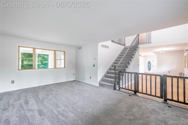 12631 9 Mile Rd, South Lyon, MI 48178 - unfurnished living room with carpet floors, stairway, and baseboards