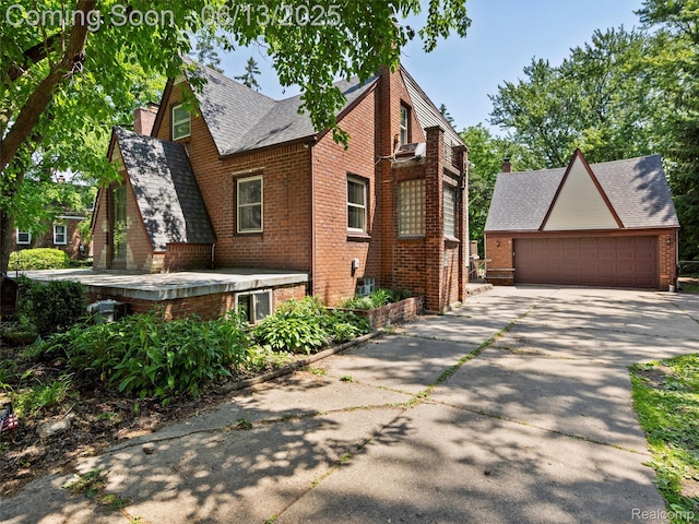 27904 Milton Ave, Warren, MI 48092 - view of front of home featuring brick siding, a shingled roof, a garage, and a chimney