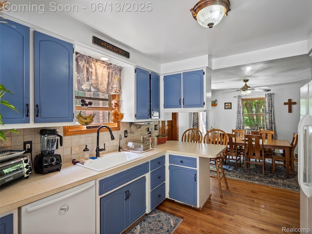 27904 Milton Ave, Warren, MI 48092 - kitchen featuring blue cabinets, a peninsula, tasteful backsplash, and wood finished floors