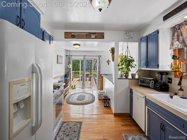 27904 Milton Ave, Warren, MI 48092 - kitchen with white appliances, blue cabinetry, and light wood-style floors