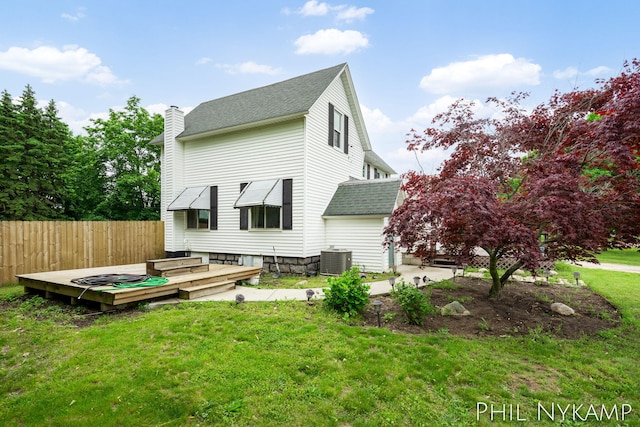 6810 Pierce St, Allendale, MI 49401 - rear view of property with roof with shingles, cooling unit, a chimney, and a wooden deck