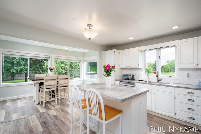 6810 Pierce St, Allendale, MI 49401 - kitchen with a sink, healthy amount of natural light, white cabinets, light wood finished floors, and recessed lighting