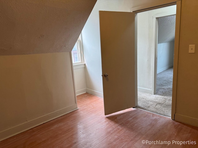 1257 3rd St, Muskegon, MI 49441 - bonus room with a textured ceiling, lofted ceiling, wood finished floors, and baseboards