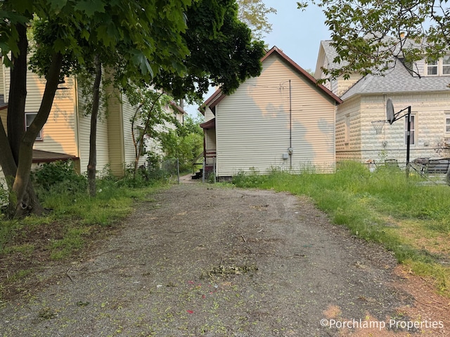 1257 3rd St, Muskegon, MI 49441 - view of side of property featuring a shingled roof