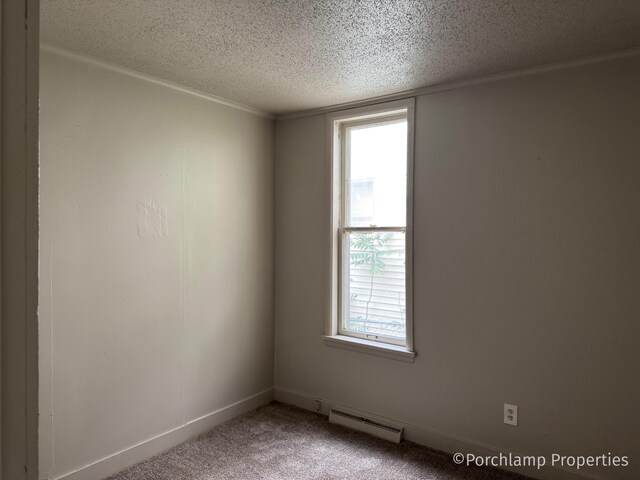 1257 3rd St, Muskegon, MI 49441 - carpeted empty room featuring a baseboard heating unit and a textured ceiling