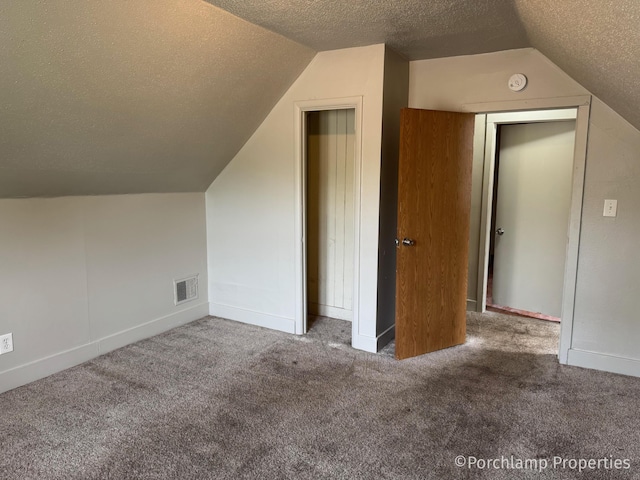 1257 3rd St, Muskegon, MI 49441 - bonus room featuring a textured ceiling, lofted ceiling, and carpet floors