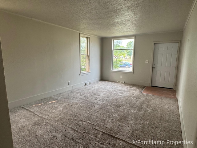 1257 3rd St, Muskegon, MI 49441 - spare room featuring a textured ceiling, carpet floors, and baseboards
