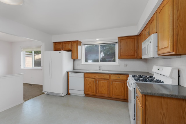 3604 Pall Dr, Warren, MI 48092 - kitchen featuring white appliances, brown cabinets, tasteful backsplash, and a sink