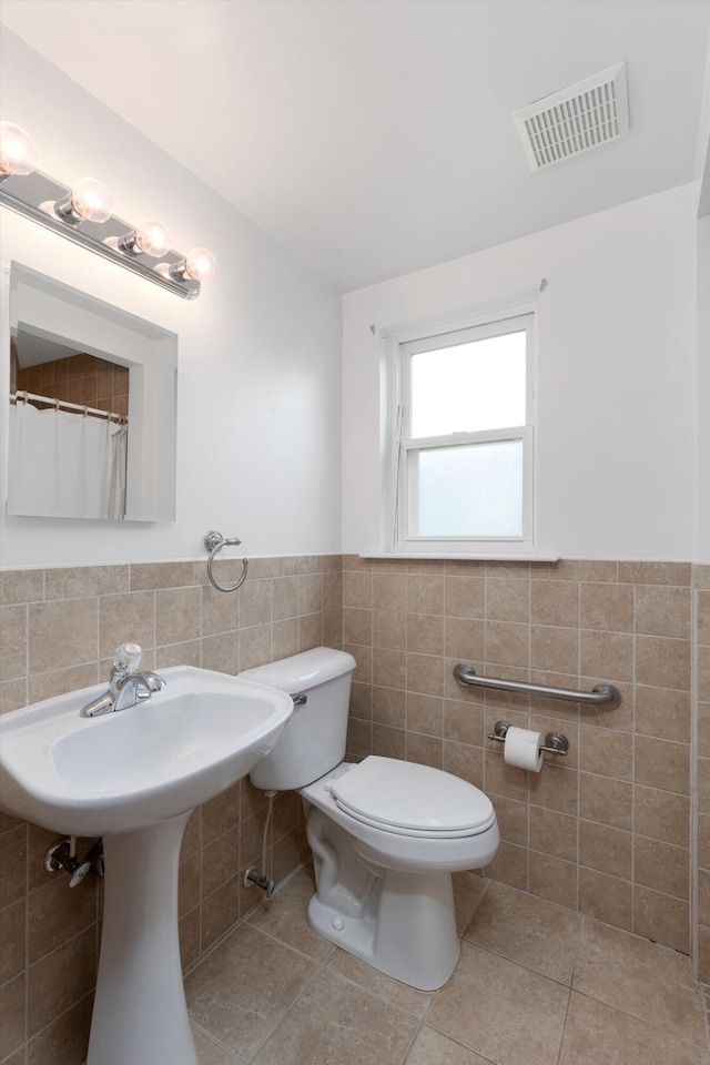 3604 Pall Dr, Warren, MI 48092 - full bathroom with tile walls, toilet, tile patterned flooring, and wainscoting